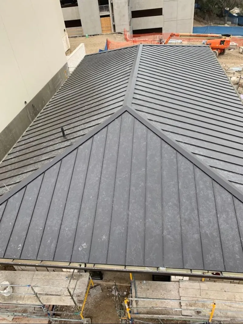 Commercial metal roof construction with crane equipment in Sweet Home