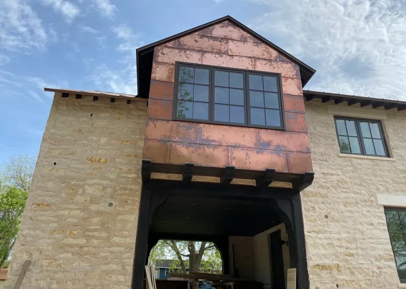 Copper metal panel facade on a stone building for Roof Repair in Sweet Home